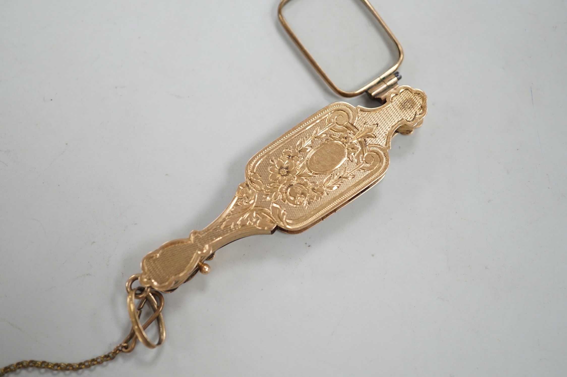 A pair of early 20th century engraved yellow metal overlaid lorgnettes.